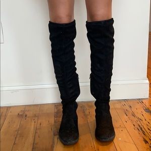 Knee high black form fitting tie boots